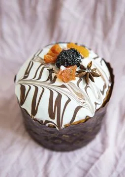 A delicious Easter cake, adorned with a marbled chocolate and white icing, is Stock Photos
