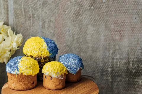 Delicious Easter cake and ingredients on wooden table. Stock Photos