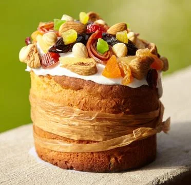 Delicious Easter Cake decorated with sweets, dried fruits and nuts, bounded u Stock Photos
