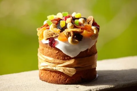 Delicious Easter Cake decorated with sweets, dried fruits and nuts, bounded u Stock Photos