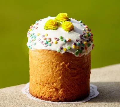 Delicious Easter Cake decorated with white sugar glaze, yellow roses and swee Stock Photos