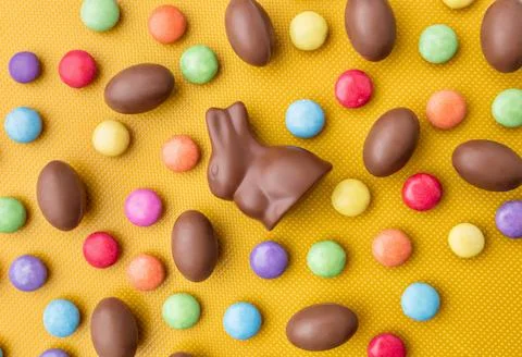 Delicious Easter chocolate bunny, eggs and sweets Stock Photos