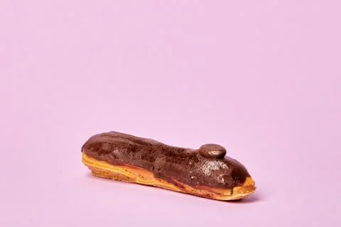 Delicious Eclair in chocolate glaze. Dark chocolate. Stock Photos