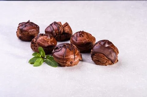 Delicious eclair covered with chocolate isolated on white, top view Stock Photos