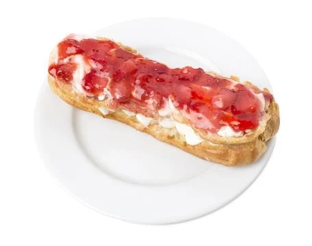 Delicious eclair with strawberry jam. Stock Photos