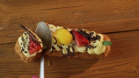 Delicious Eclair Topped With Fresh Fruit and Cream on Wooden Table in Afternoon Stock-Footage 275892486