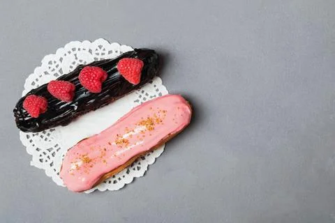 Delicious eclairs with raspberry and chocolate Stock Photos