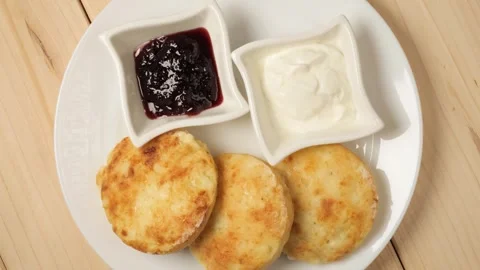 Delicious farmer cheese pancakes rotating on a plate Stock Footage 340159624