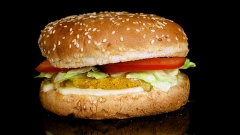 Delicious Fish Burger on black background with reflection, loop Stock Footage 75253871