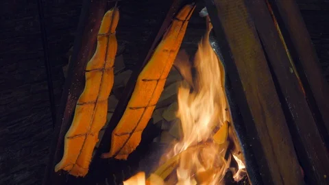 Delicious flamed Salmon is smoked on open fire Stock Footage