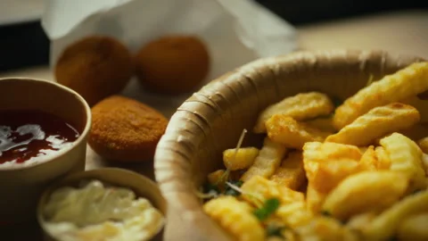 Delicious food spread featuring crispy fries and savory snacks ideal for a c Stock Footage 301344423