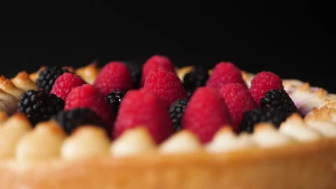 Delicious forest fruit cake turning against black background 스톡 동영상 167622582
