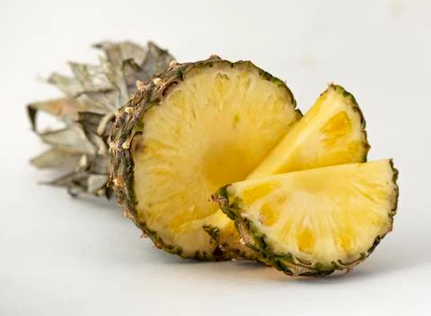 Delicious fragrant appetizing pineapple cut into slices for dessert with a li Stock Photos