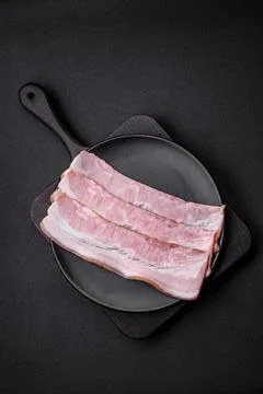Delicious fresh bacon stripes with spices and salt Stock Photos