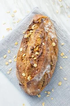 Delicious fresh baked bread on rustic background. Stock Photos