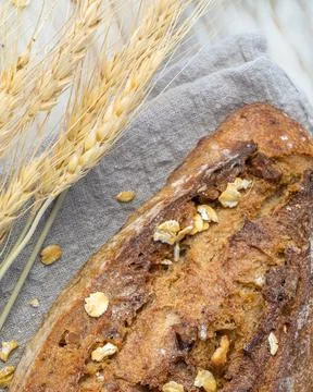 Delicious fresh baked bread on rustic background. Stock Photos