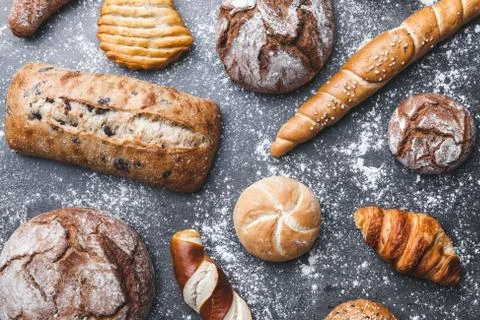 Delicious fresh bread on rustic background Stock Photos