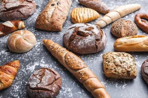 Delicious fresh bread on rustic background Stock Photos