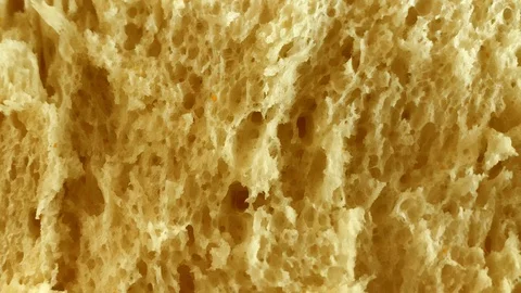Delicious fresh bread. The texture of the bread. Macro footage. Stock footage 4K 스톡 동영상 104626652