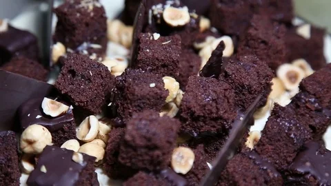 Delicious fresh cake with nuts and chocolate on a spinning table close-up. Stock Footage 83511624