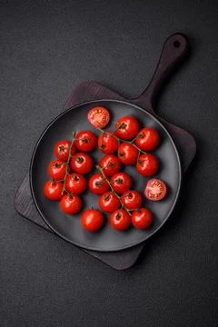 Delicious fresh cherry tomatoes on the branches as an ingredient for cookin.. Stock Photos