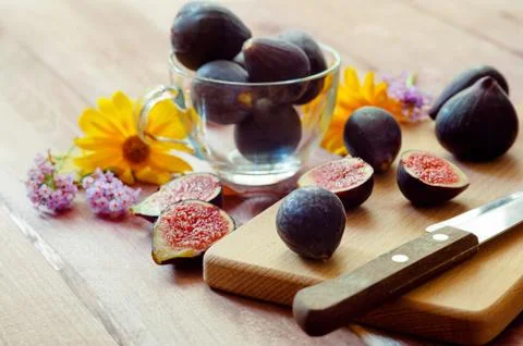 Delicious fresh dark figs on a chopping board Stock Photos