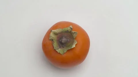 Delicious Fresh Persimmon Fruit Displayed Beautifully on a Clean White Stockbeeldmateriaal 289833538
