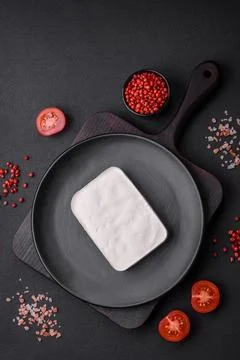 Delicious fresh rectangular shaped feta cheese with spices and vegetables Foto stock