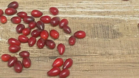 Delicious Fresh Red Cherry Tomatoes Resting on a Rustic Wooden Background Видео 283900764