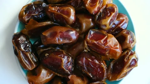 Delicious fresh ripe dates rotating in a plate Stock Footage 337893164