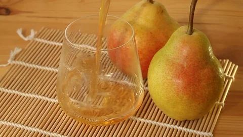 Delicious fresh squeezed pear juice in  transparent glass Stock Footage 129123525