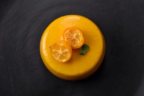 Delicious fresh tartlet with citrus filling and decorated with passion fruit  Stock Photos