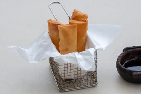 Delicious fried and crispy spring rolls served with sauce. in Brazil called t Stock Photos