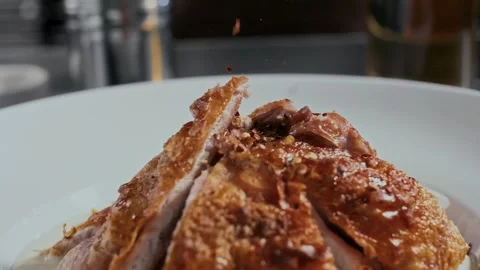 Delicious fried chicken with a crispy crust is sprinkled with spices on a plate Stock Footage 315230360