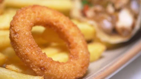 Delicious fried onion ring and crispy fries served together Stock Footage 305978633