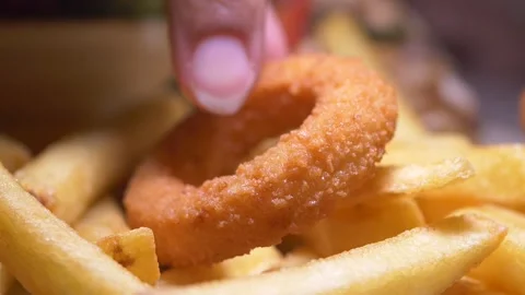 Delicious fried onion ring on a bed of crispy fries Stock Footage 316666374