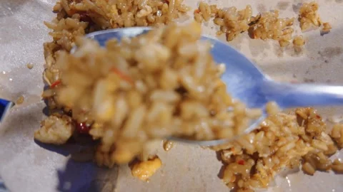 Delicious fried rice being scooped with a spoon from a plate. Video stock 343376889