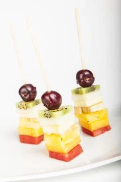Delicious fruit kabobs isolated over white Stock Photos