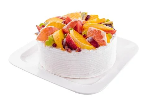 Delicious fruit mousse cake on white plate Stock Photos