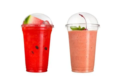 Delicious fruit smoothies in plastic cups, on a white background. Two cocktai Stock Photos