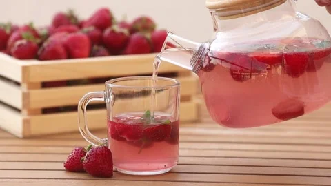 Delicious fruity berry tea with strawberry and mint in glass teapot Stock Footage 200089613
