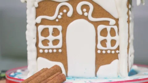 Delicious gingerbread house on a blurred background with colorful bokeh Stock Footage 75540009