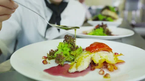 Delicious gourmet dish is being given the finishing touches by the chef Stock Footage