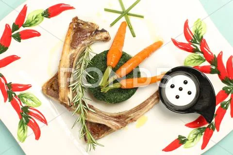 Delicious gourmet food with ribs and carrots Stock Photos