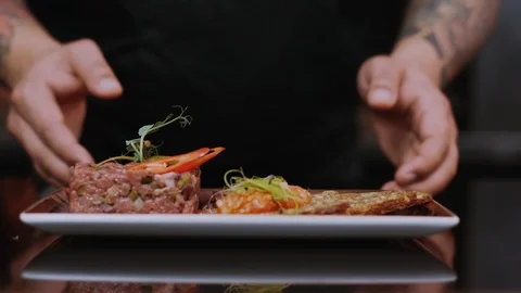 Delicious gourmet meal is being given the finishing touches by the chef in Stock Footage