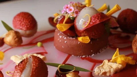 Delicious gourmet meal with flowers restaurant hotel kitchen plating by the chef Stock Footage 78715682