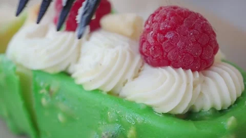 Delicious green cake with raspberries on top Stock Footage 343230516