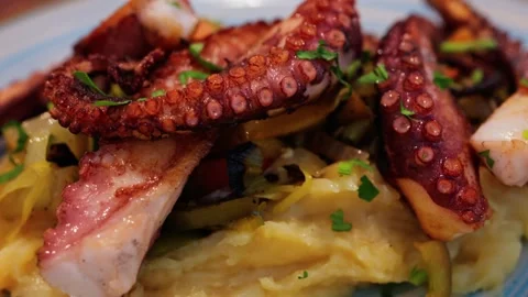 Delicious grilled octopus tentacles served with mashed potatoes and vegetab.. Stock Footage 339652448