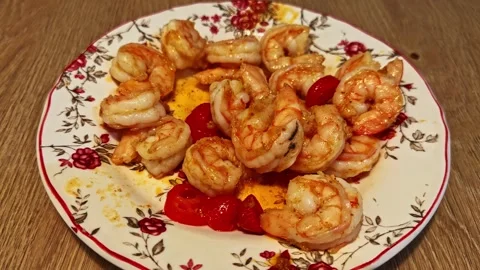 Delicious grilled prawns with vegetables served on a floral plate for dinner Stock Footage 346189572