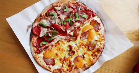 Delicious half-and-half pizza on wooden table, featuring pepperoni, Stock Footage 317449121